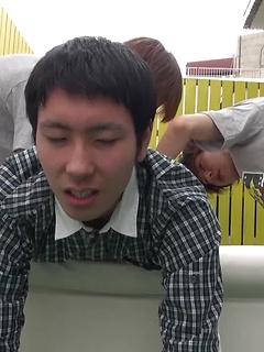 Kaede and Fuji grab the lube and a dildo and bend Jo over the small couch pulling off his shorts